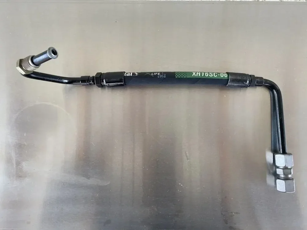 A picture of the front brake hose on a car.