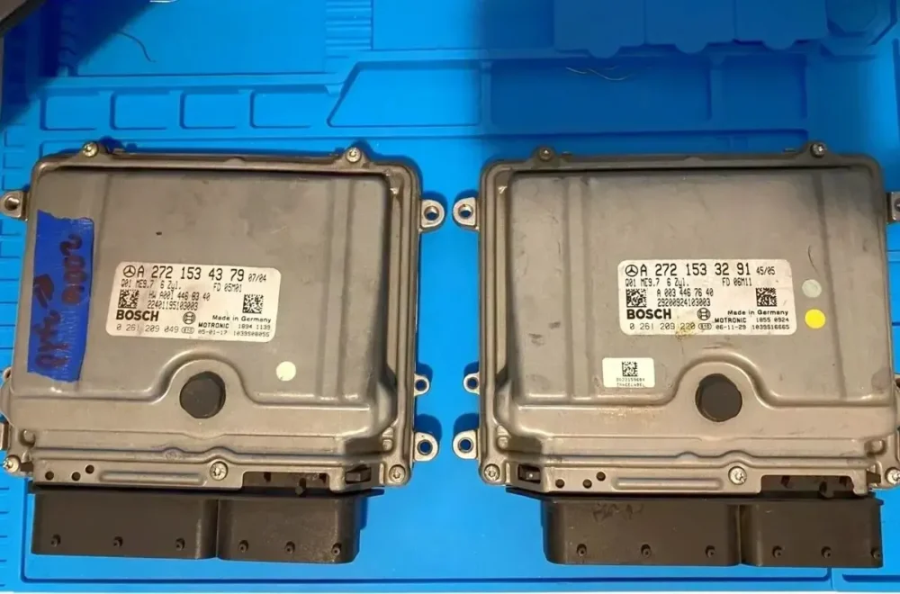 Two identical electronic modules are sitting on a blue tray.